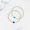 Nazar evil eye bracelets with silver beads and blue evil eye beads.