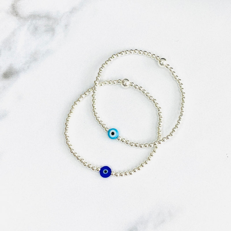 Nazar evil eye bracelets with silver beads and blue evil eye beads.