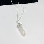 Rose quartz gemstone on silver necklace.