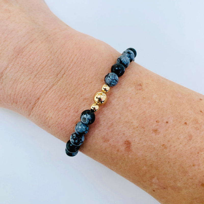 Gemstone bracelet with snowflake obsidian gemstone beads and 14k gold filled beads. Bracelet accessory in black.