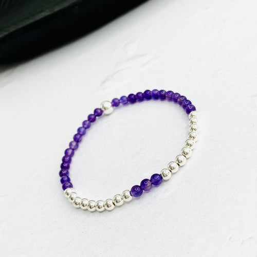 Amethyst bead bracelet with purple gemstone beads and silver beads.