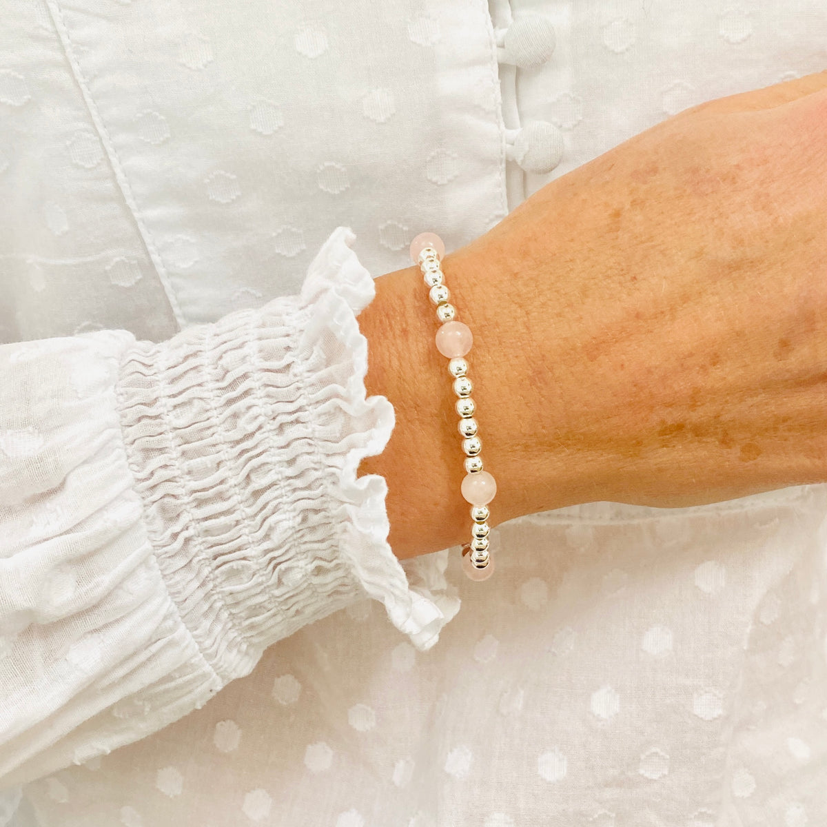 Rose quartz gemstone bracelet with sterling silver beads.