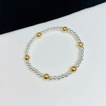 Handmade bracelet with silver and gold beads.