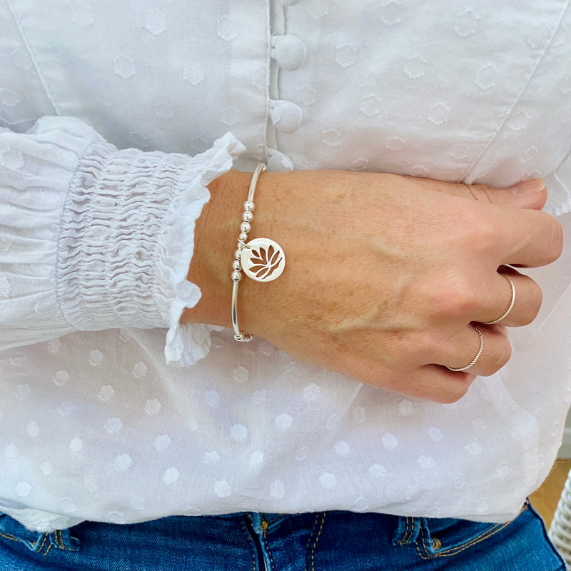 Silver bracelet with pretty lotus flower charm.