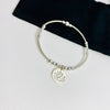 Ladies silver bead bracelet with flower charm.