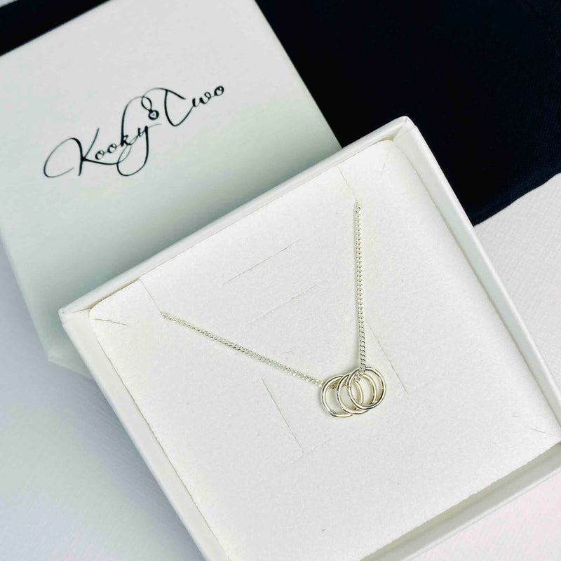 Meaningful necklace with silver rings to represent family in sterling silver. KookyTwo