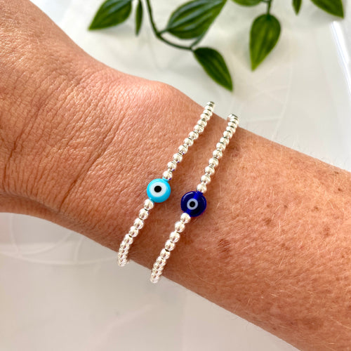 Dainty evil eye protective bracelet with sterling silver beads. Choose from turquoise evil eye bead or vibrant blue evil eye bead.