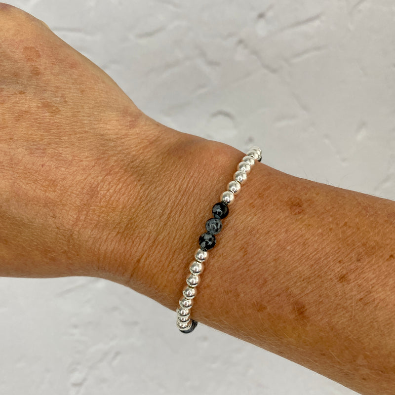 Silver bead bracelet handmade with sterling silver beads and snowflake obsidian gemstones