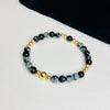 Gemstone bead bracelet with gold beads.