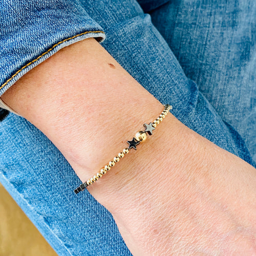 Dainty gold bracelet with star beads. Hematite star beads with gold beads.