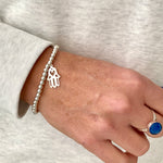 Sterling silver bracelet with hamsa hand charm. Blue lapis lazuli ring also available at KookyTwo.