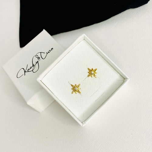 Pretty gold star stud earrings in gift box. KookyTwo.