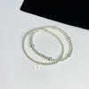 Stacking bracelet set with sterling silver bracelets. Silver sun charm bracelet and plain silver bead bracelet.