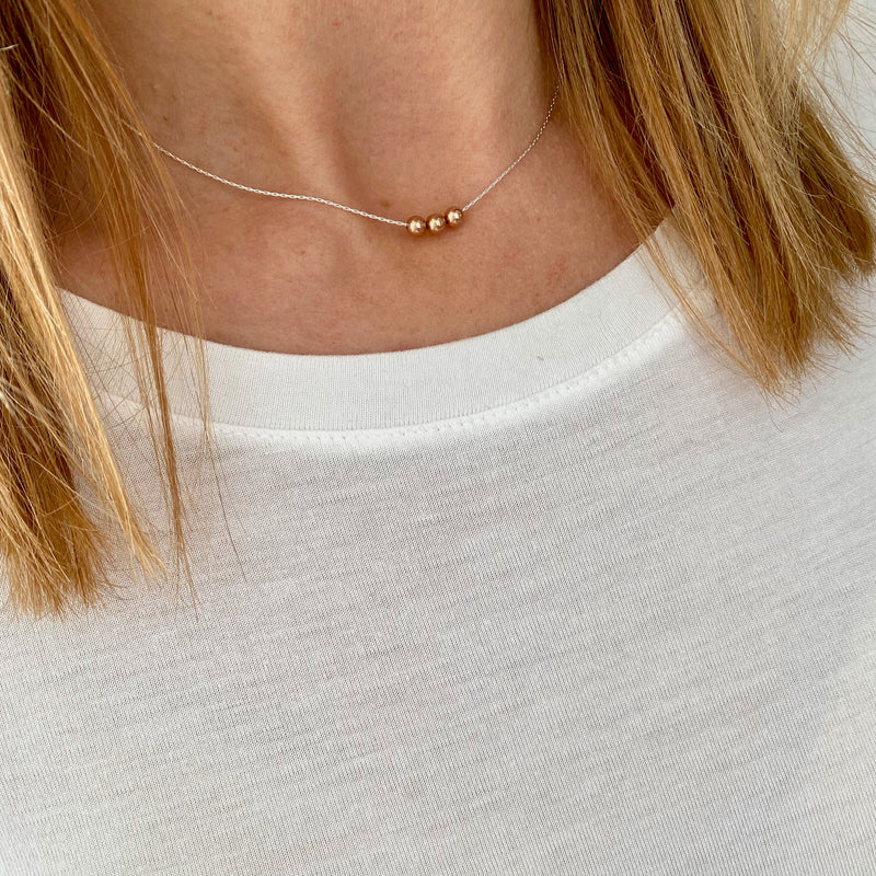 Three lovely rose gold beads on a dainty silver chain. Kooky Two.