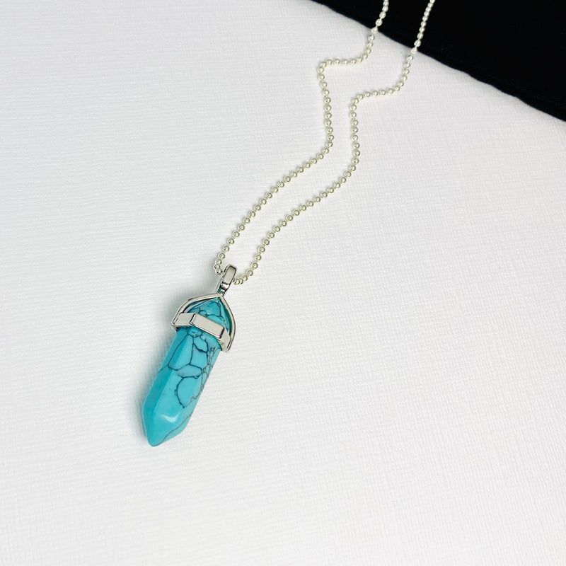 Turquoise charm necklace with point pendant on silver chain. KookyTwo.